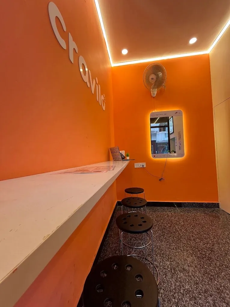 Counter seating along the orange wall